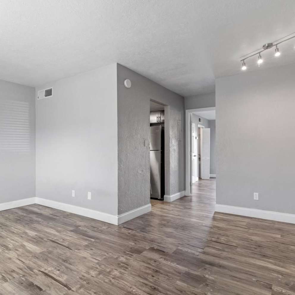 A room with wooden flooring and a white ceiling.